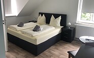 Schlafzimmer in der Pension Krug zum Schlaubetal, Foto: Pension Krug zum Schlaubetal