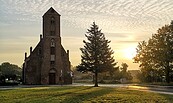 Eine Kapelle im Sonnenuntergang mit einer Wiese davor, Foto: Merith Sommer, Lizenz: TMU GmbH