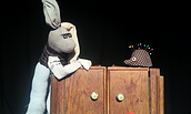 Zwei Stofftiere auf einem kleinen Holzschrank, links ein Hase mit Brille und Pullover, rechts ein Igel mit bunten Stecknadeln im Rücken, Foto: Nicole Weißbrodt, Lizenz: Nicole Weißbrodt